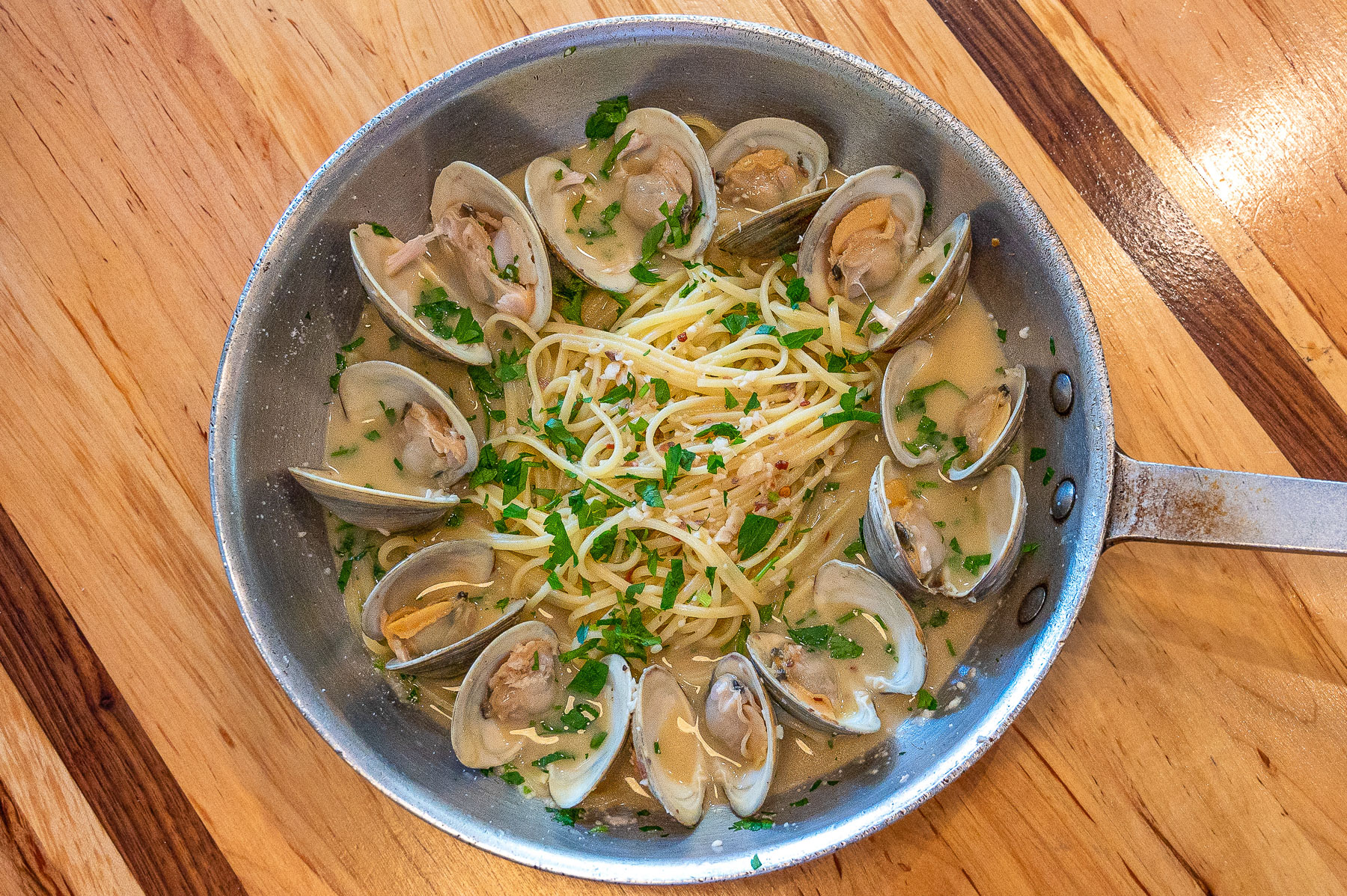 Littleneck clams are simmered in olive oil, garlic, and white wine sauce. Served over a bed of al dente linguine!